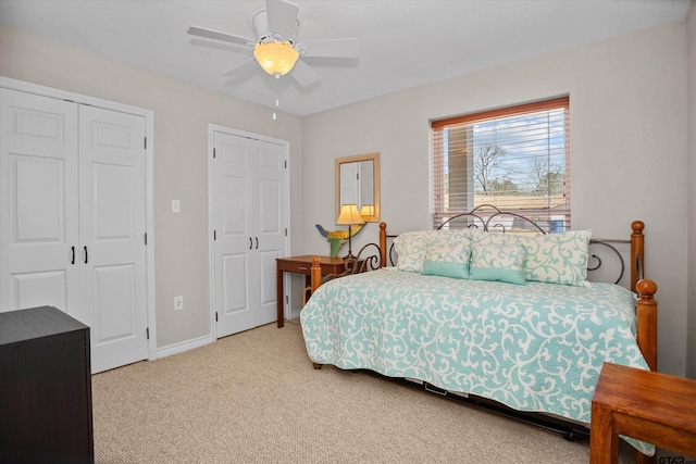 160 Lookout Point Dr, Grapeland, TX 75844 - bedroom featuring multiple closets, light carpet, ceiling fan, and baseboards