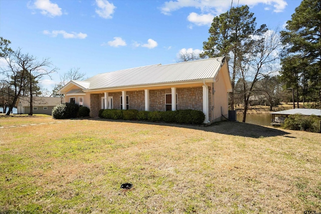 160 Lookout Point Dr, Grapeland, TX 75844 - ranch-style home with a front yard, stone siding, metal roof, and central AC unit