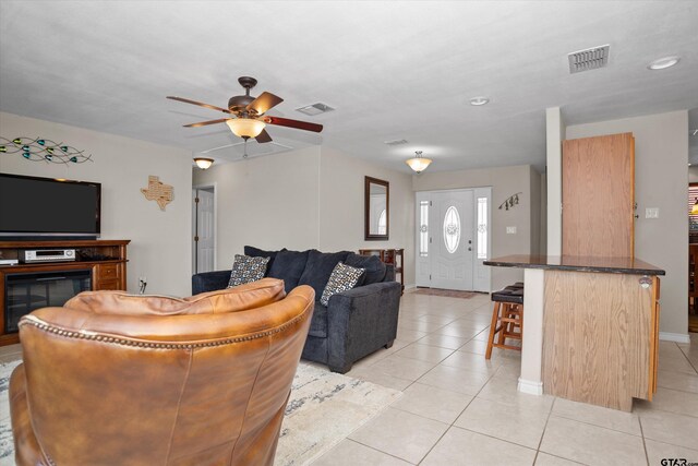 160 Lookout Point Dr, Grapeland, TX 75844 - living room with a ceiling fan, a glass covered fireplace, visible vents, and light tile patterned floors