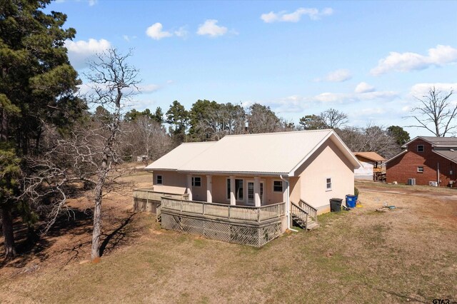 160 Lookout Point Dr, Grapeland, TX 75844 - view of front of property with stucco siding, metal roof, and a front yard