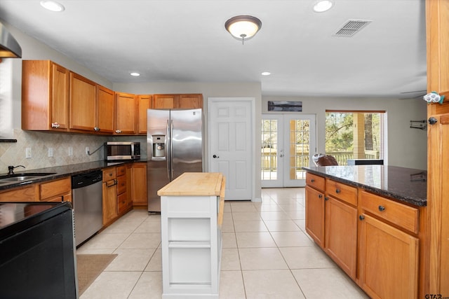 160 Lookout Point Dr, Grapeland, TX 75844 - kitchen featuring french doors, light tile patterned floors, visible vents, appliances with stainless steel finishes, and a kitchen island