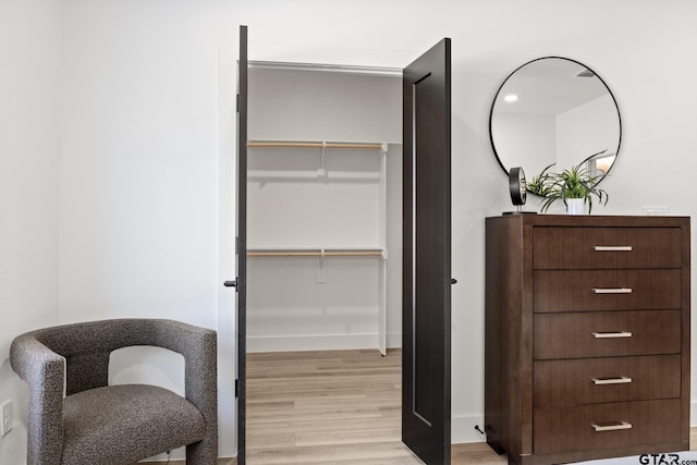 interior space with baseboards and light wood finished floors