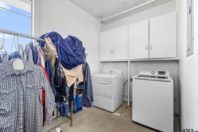 clothes washing area featuring cabinets and washing machine and clothes dryer