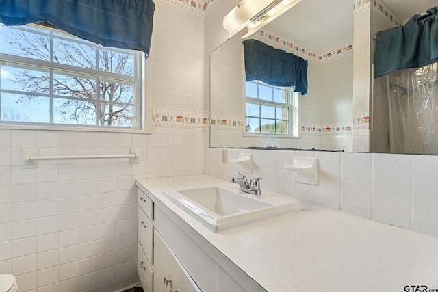 bathroom featuring tile walls and vanity