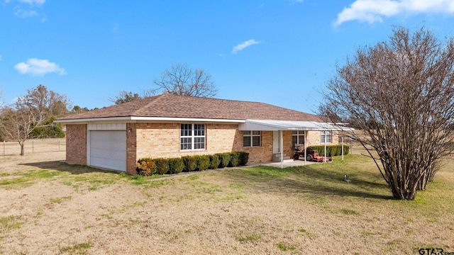 ranch-style home with a front lawn and a garage