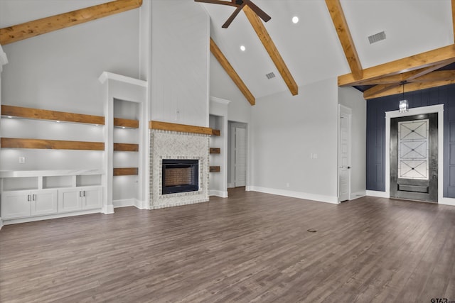 unfurnished living room featuring dark wood-type flooring, ceiling fan, beam ceiling, high vaulted ceiling, and a fireplace