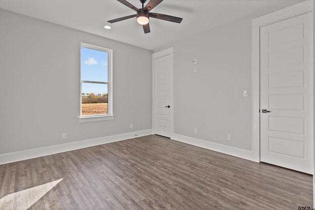 spare room featuring wood-type flooring and ceiling fan