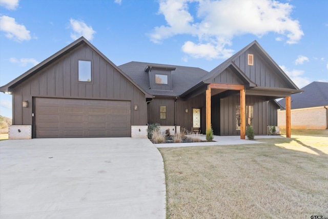 view of front of home with a front yard and a garage