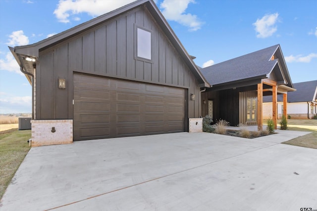 modern farmhouse featuring a garage and cooling unit