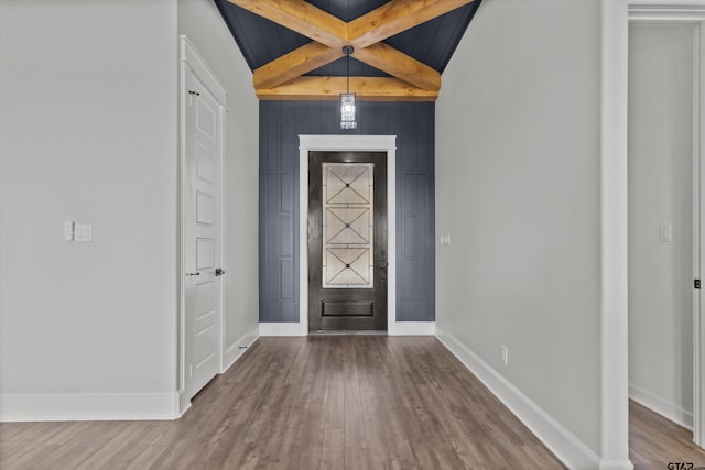 foyer with hardwood / wood-style flooring and beam ceiling