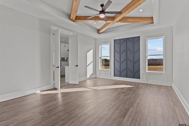 unfurnished room with ceiling fan, coffered ceiling, light hardwood / wood-style floors, and beam ceiling