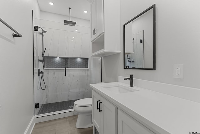 bathroom with tile patterned flooring, toilet, vanity, and walk in shower