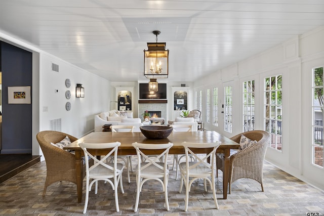 2417 Old Bullard Rd, Tyler, TX 75701 - dining room with a warm lit fireplace and baseboards