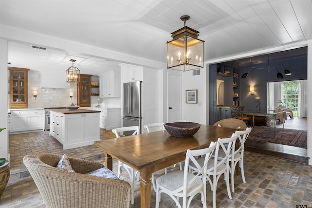 2417 Old Bullard Rd, Tyler, TX 75701 - dining area with a chandelier and brick floors