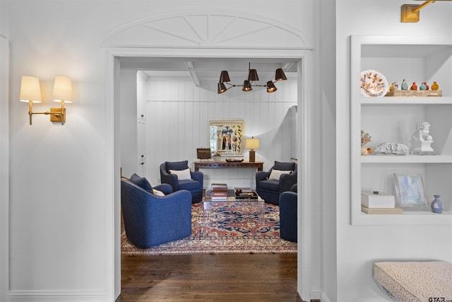 2417 Old Bullard Rd, Tyler, TX 75701 - living room featuring wood finished floors, a chandelier, and built in shelves