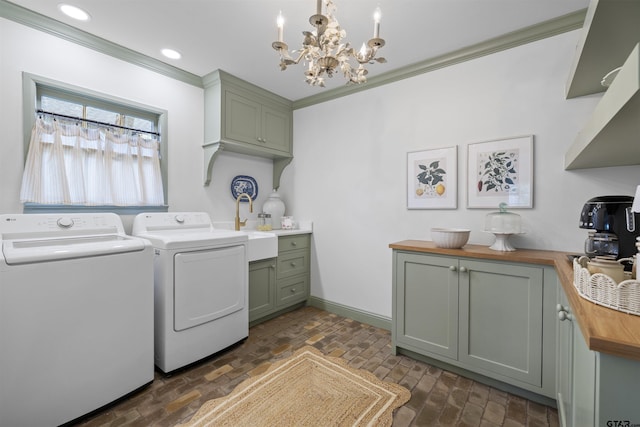 2417 Old Bullard Rd, Tyler, TX 75701 - laundry room with washer and dryer, a chandelier, brick flooring, cabinet space, and ornamental molding