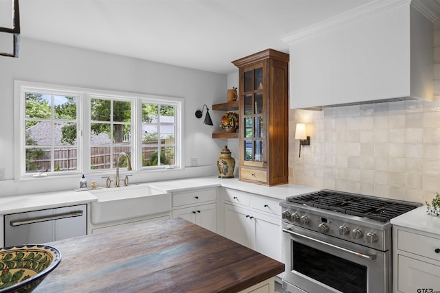 2417 Old Bullard Rd, Tyler, TX 75701 - kitchen with appliances with stainless steel finishes, tasteful backsplash, wood counters, and white cabinetry