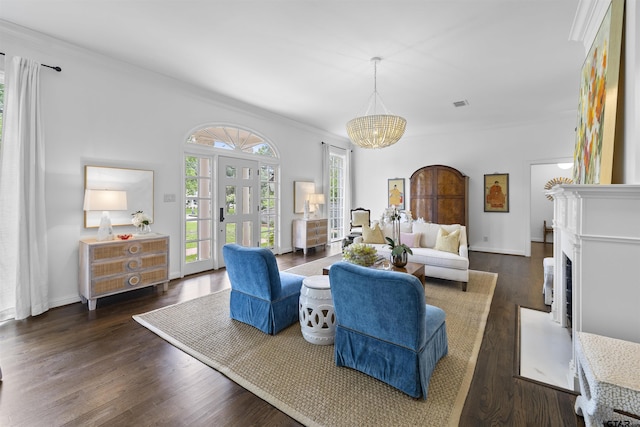 2417 Old Bullard Rd, Tyler, TX 75701 - living area featuring ornamental molding, a chandelier, dark wood-type flooring, a fireplace with flush hearth, and french doors