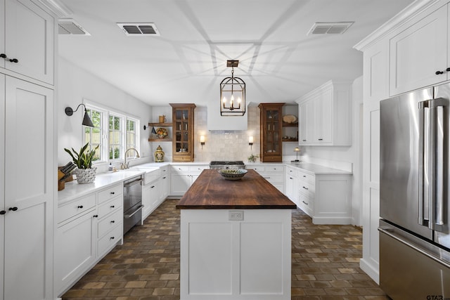 2417 Old Bullard Rd, Tyler, TX 75701 - kitchen featuring stainless steel appliances, butcher block counters, open shelves, tasteful backsplash, and a center island