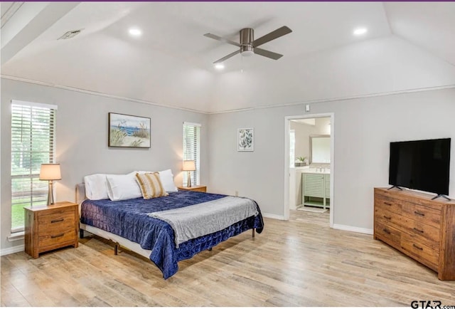 bedroom featuring ceiling fan, ensuite bathroom, light hardwood / wood-style floors, and lofted ceiling