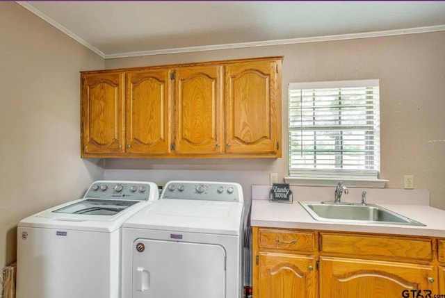 clothes washing area with cabinets, ornamental molding, separate washer and dryer, and sink