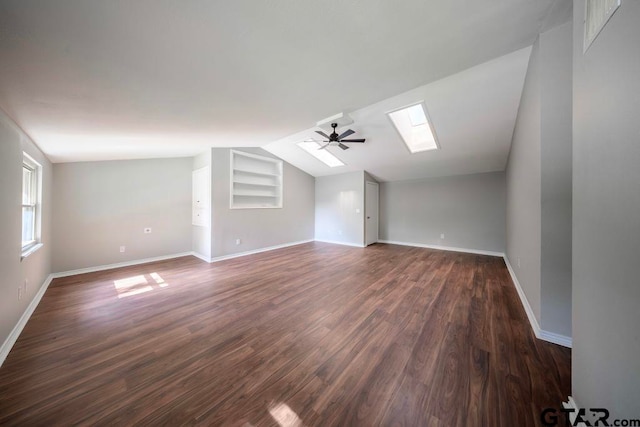 411 Lakeview St, Whitehouse, TX 75791 - bonus room featuring lofted ceiling, a skylight, a ceiling fan, dark wood-type flooring, and built in shelves