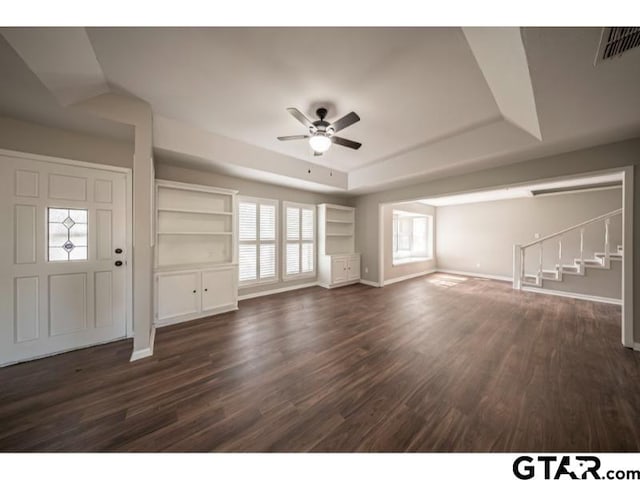 411 Lakeview St, Whitehouse, TX 75791 - unfurnished living room with a ceiling fan, dark wood-type flooring, a raised ceiling, and stairway