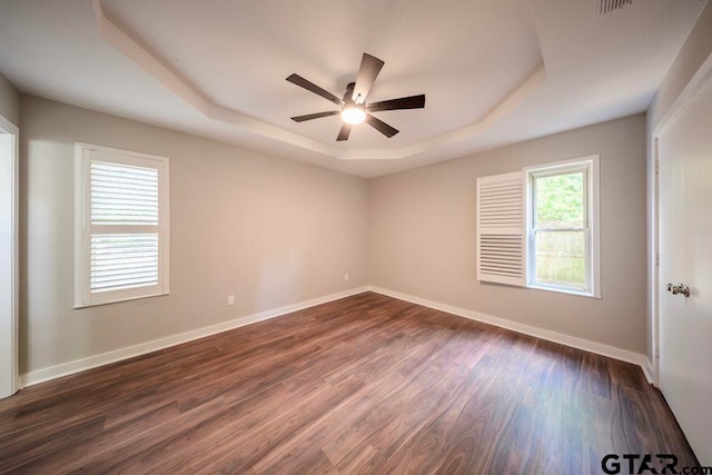 411 Lakeview St, Whitehouse, TX 75791 - unfurnished room with a tray ceiling, a ceiling fan, and dark wood finished floors