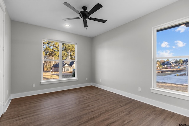 unfurnished room featuring dark hardwood / wood-style floors, a healthy amount of sunlight, and ceiling fan