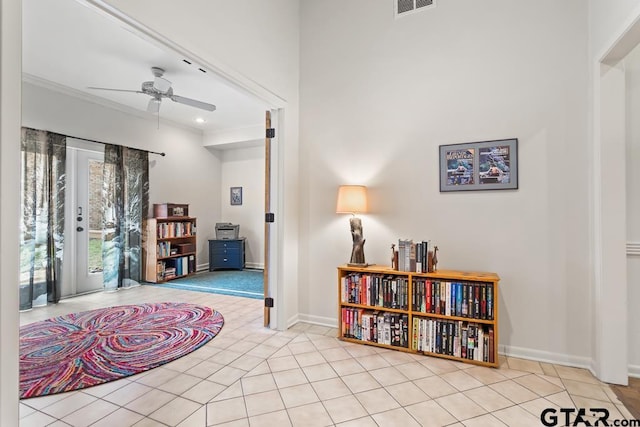 sitting room featuring light tile patterned floors, ceiling fan, visible vents, and baseboards