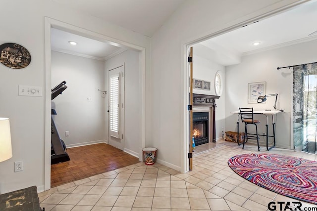 foyer entrance featuring recessed lighting, ornamental molding, light tile patterned flooring, a warm lit fireplace, and baseboards