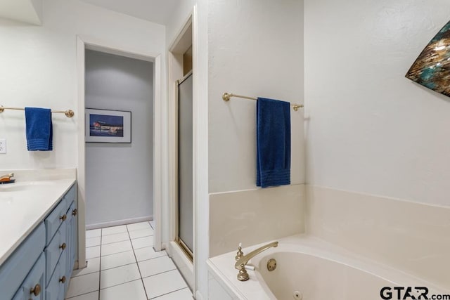 bathroom featuring a stall shower, vanity, a whirlpool tub, and tile patterned floors