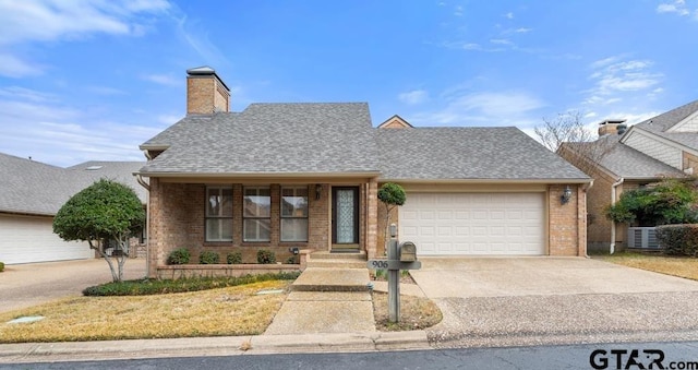 906 Woodhall Pl, Tyler, TX 75703 - view of front of home featuring brick siding, driveway, a garage, and roof with shingles
