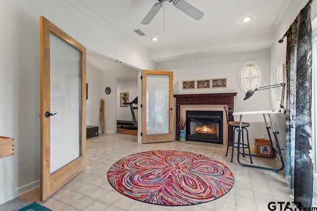 living area featuring light tile patterned floors, recessed lighting, visible vents, a glass covered fireplace, and crown molding