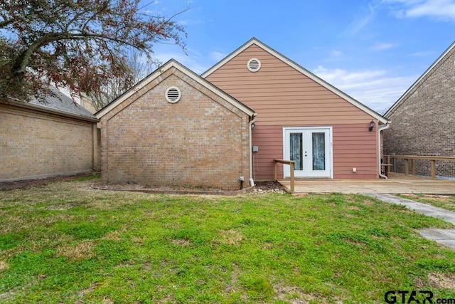 back of house featuring a yard, french doors, and brick siding