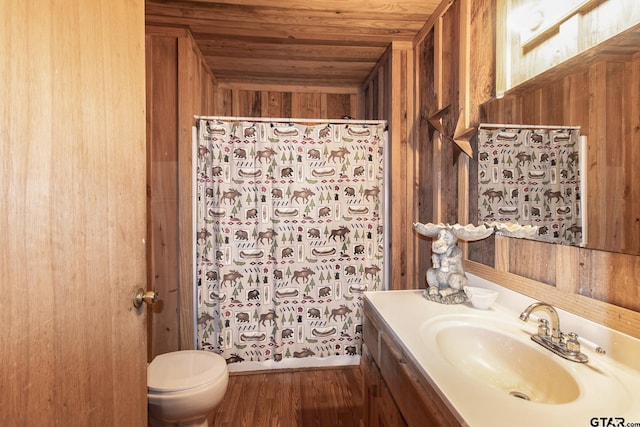 bathroom featuring hardwood / wood-style flooring, vanity, wood walls, and wood ceiling