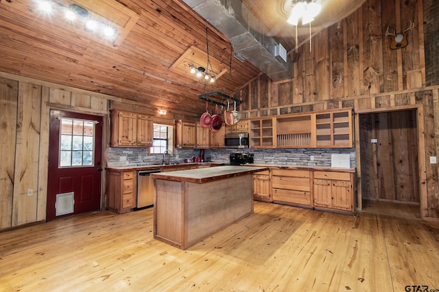 kitchen featuring a kitchen island, lofted ceiling, stainless steel appliances, and light hardwood / wood-style flooring