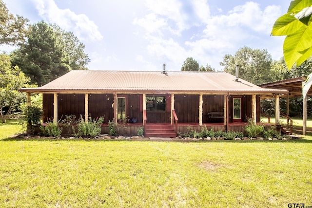 back of property with a porch and a yard