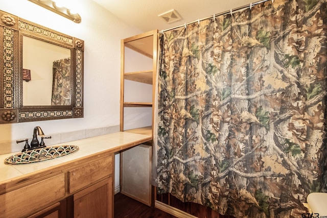 bathroom featuring a shower with curtain, vanity, and hardwood / wood-style flooring