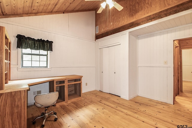 unfurnished office featuring light hardwood / wood-style floors, lofted ceiling, and wood walls