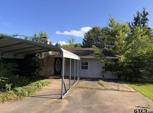 119 County Road 1440, Mount Pleasant, TX 75455 - view of front of property with a chimney and a carport