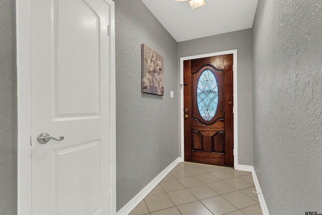 8811 Pheasant Dr, Chandler, TX 75758 - entryway with light tile patterned flooring, a textured wall, and baseboards