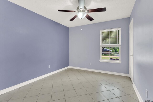 8811 Pheasant Dr, Chandler, TX 75758 - unfurnished room featuring a ceiling fan, baseboards, and light tile patterned floors