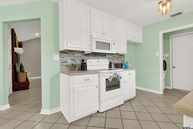 8811 Pheasant Dr, Chandler, TX 75758 - kitchen featuring white appliances, light tile patterned flooring, light countertops, tasteful backsplash, and white cabinets