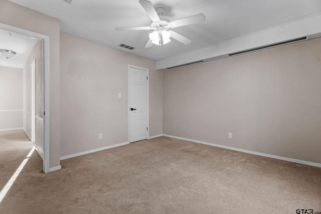 carpeted spare room with ceiling fan