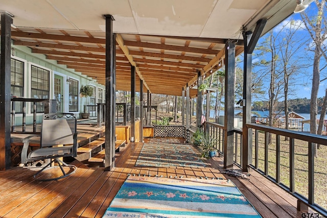 wooden deck featuring a water view