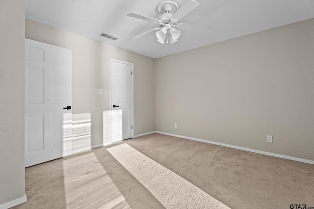 unfurnished bedroom featuring light carpet and ceiling fan