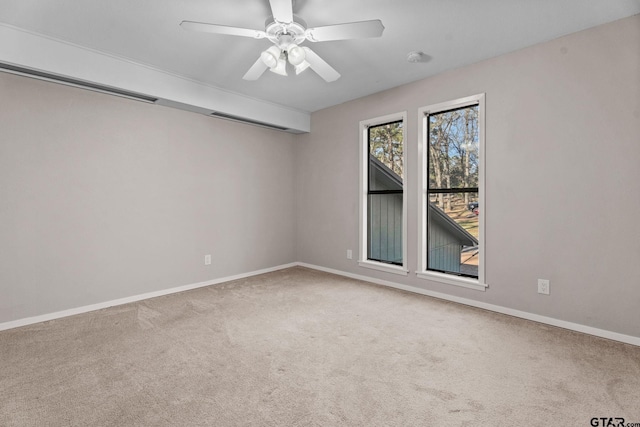 carpeted spare room with ceiling fan