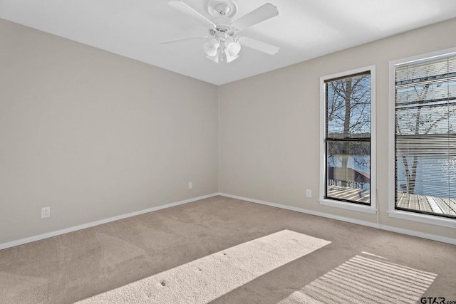 unfurnished room featuring ceiling fan and light colored carpet