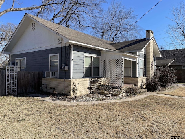 view of side of home with a yard and cooling unit